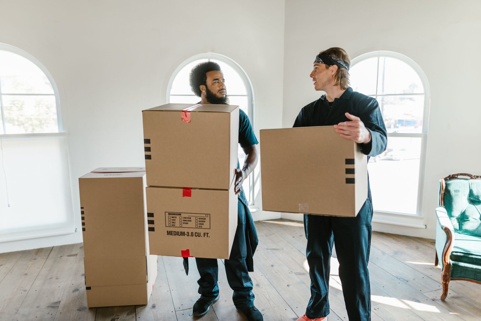 Professional movers carrying boxes during a commercial relocation